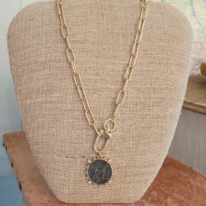 Modern gold tone chain necklace and pendant.